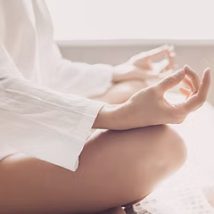 Woman relaxing outdoors representing mental wellness and stress relief